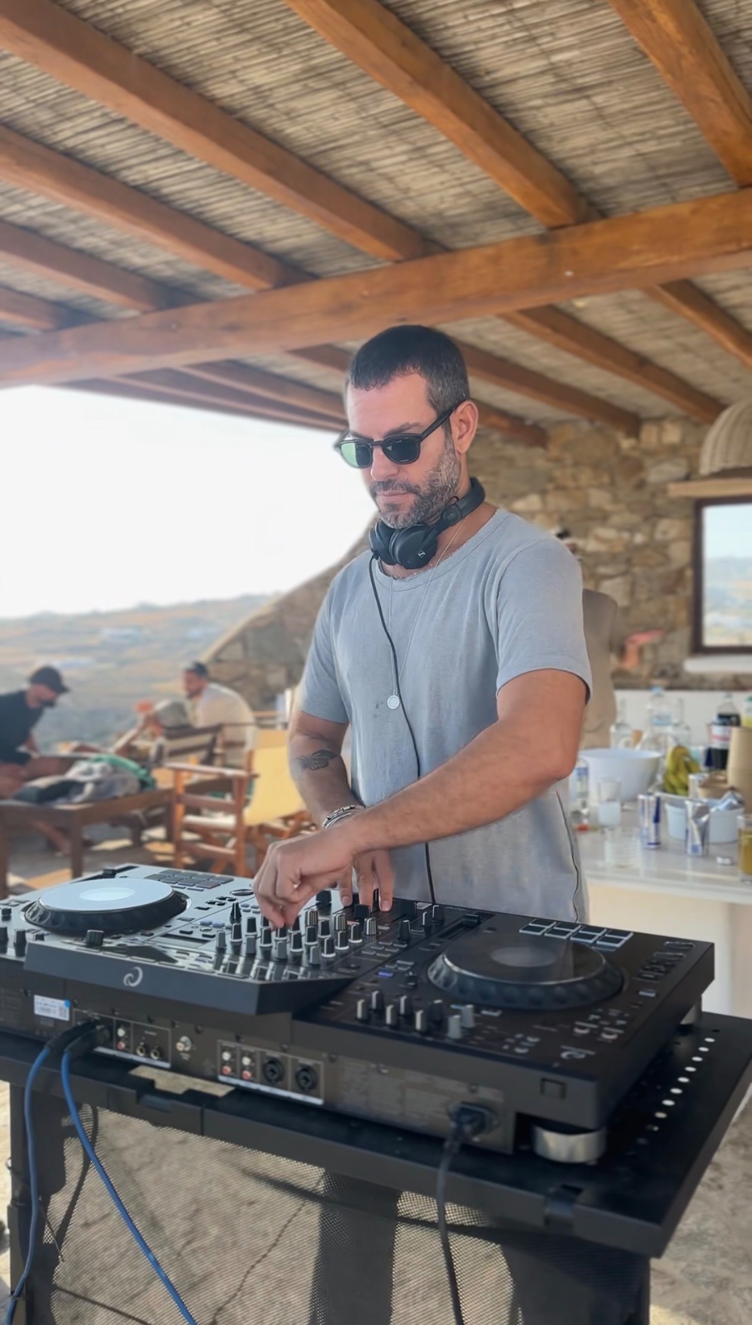 Resident DJ mixing on the villa terrace