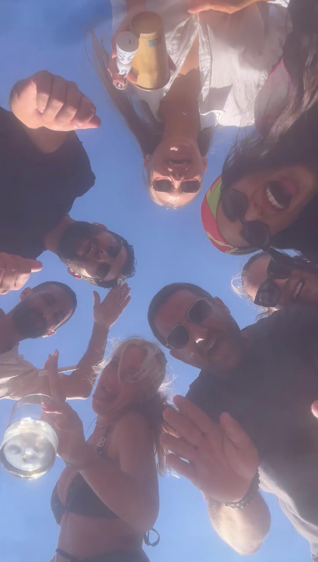Friends gathered in a circle under the Mykonos sky