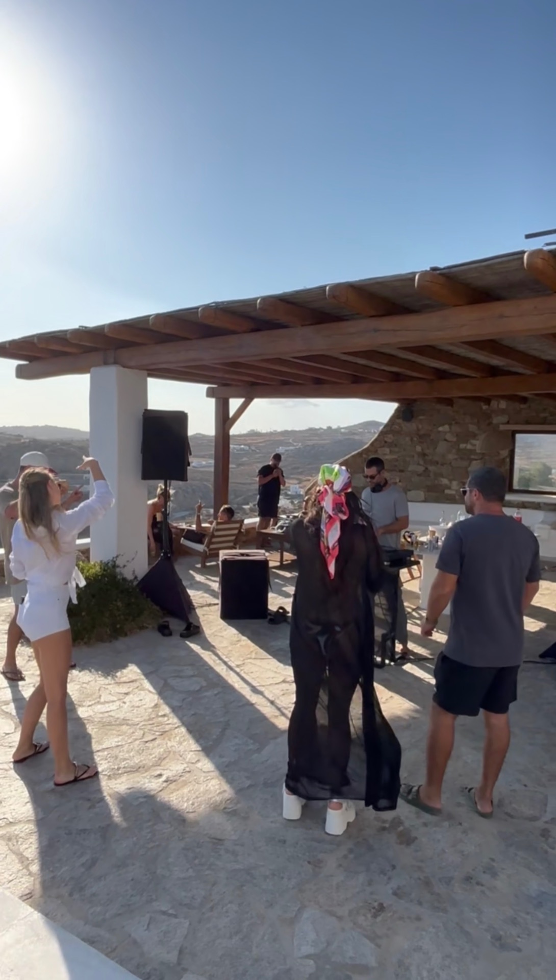 Guests dancing on the terrace at sunset