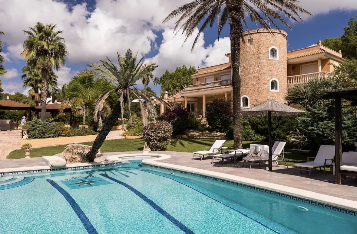 Mediterranean villa with palm trees and pool